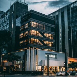 Black High Rise Building Under Grey and White Sky during Night Time